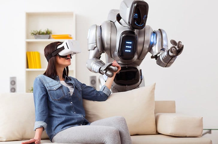 woman with VR headset holding hands with a robot